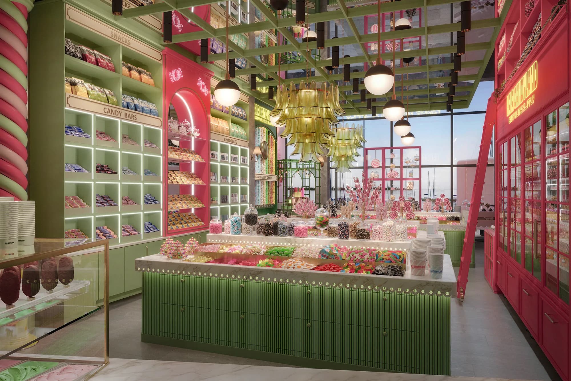 Pale green shelving with white neon-edged cubbies under cream Snacks, Candy bars and Chocolate plaques, a raspberry arched niche, gold glass chandeliers and a fluted green island counter under globe pendant lights.